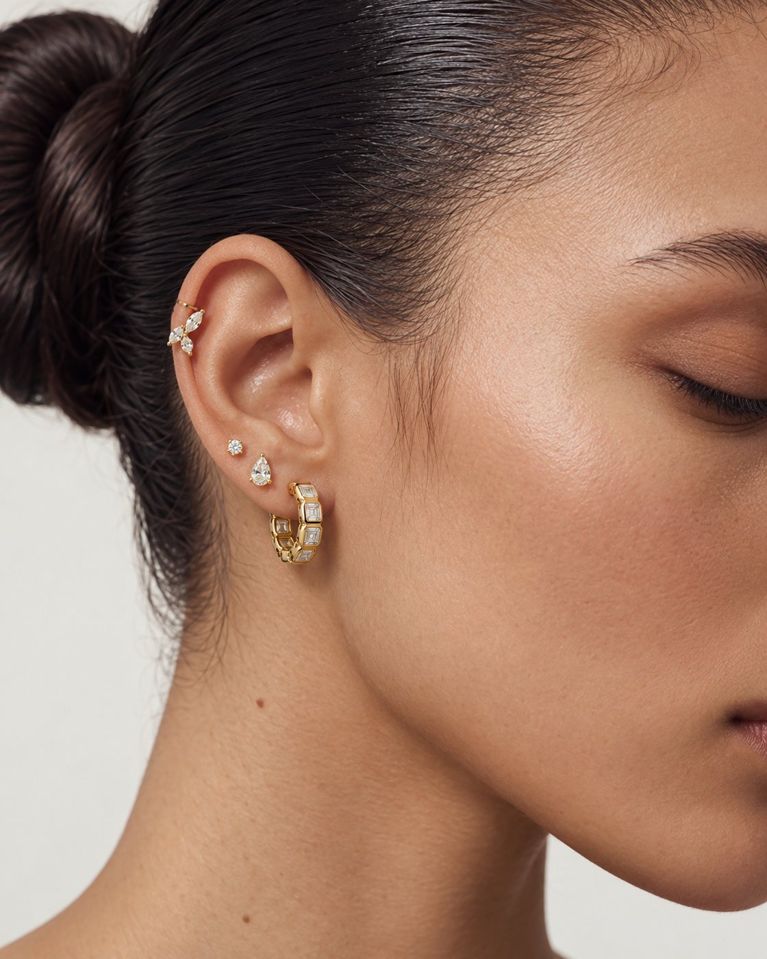 A curated ear of HERLEVÉ earrings