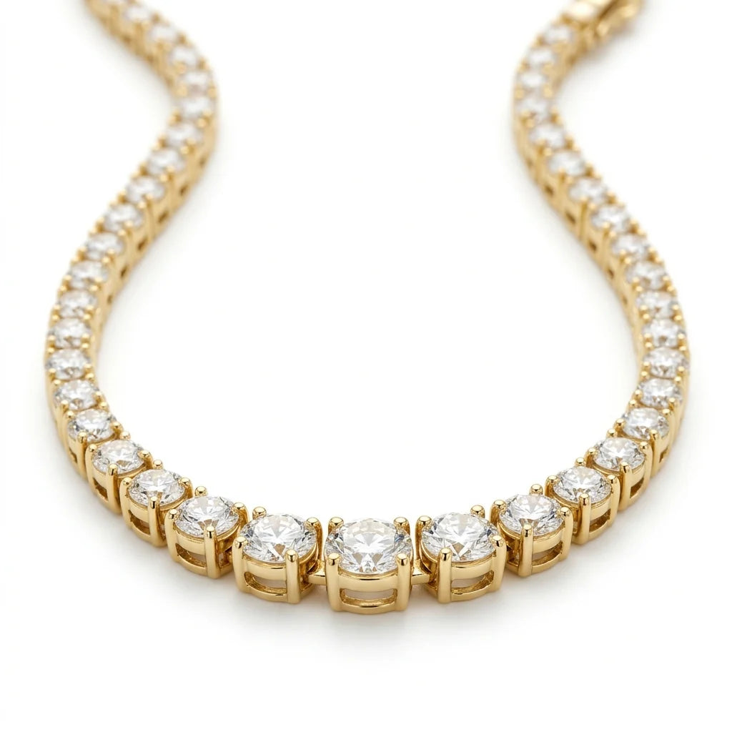 Graduated round brilliant diamond tennis necklace in 18k yellow gold on a white studio background